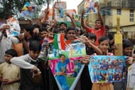 Indian cricket supporters hold posters a