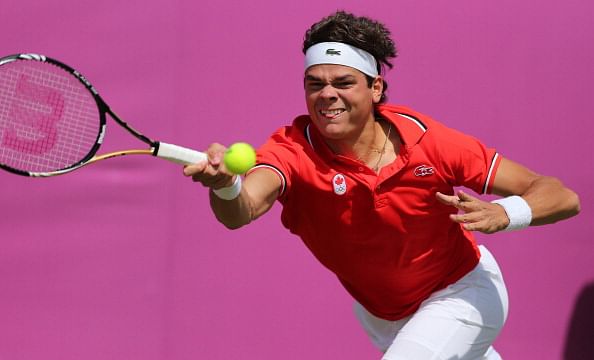 Canada&#039;s Milos Raonic returns a ball, he would beat Tatsuma Ito 6-3 6-4 in first round action in the