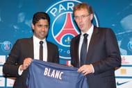 President Nasser Al-Khelaifi of Paris Saint-Germain poses with the new coach Laurent Blanc during his official presentation at the Parc de Princes stadium on June 27, 2013 in Paris, France. (Getty Images)