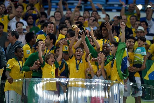 Neymar of Brazil lifts the trophy with his team-mates following their victory at the end of the FIFA Confederations Cup Brazil 2013 Final match between Brazil and Spain at Maracana on June 30, 2013 in Rio de Janeiro, Brazil.  (Getty Images)