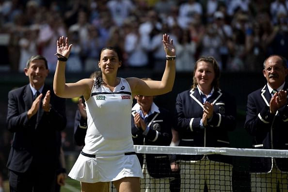  Marion Bartoli of France walks forward to receive the Venus Rosewater Dish trophy from Prince Edward, Duke of Kent after her victory in the Ladies&#039; Singles final match against Sabine Lisicki of Germany on day twelve of the Wimbledon Lawn Tennis Championships at the All England Lawn Tennis and Croquet Club on July 6, 2013 in London, England.  (Getty Images)