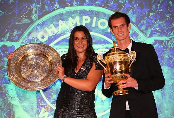 Marion Bartoli of France poses with the Venus Rosewater Dish trophy and Andy Murray of Great Britain poses with the Gentlemen&#039;s Singles Trophy at the Wimbledon Championships 2013 Winners Ball at InterContinental Park Lane Hotel on July 7, 2013 in London, England.  (Getty Images)