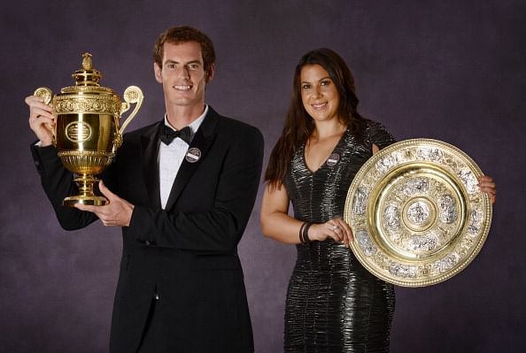 Andy Murray of Great Britain poses with the Gentlemen&#039;s Singles Trophy and Marion Bartoli of France (R) poses with the Venus Rosewater Dish trophy at the Wimbledon Championships 2013 Winners Ball at InterContinental Park Lane Hotel on July 7, 2013 in London, England.   (Photo by Bob Martin - Pool/AELTC via Getty Images)