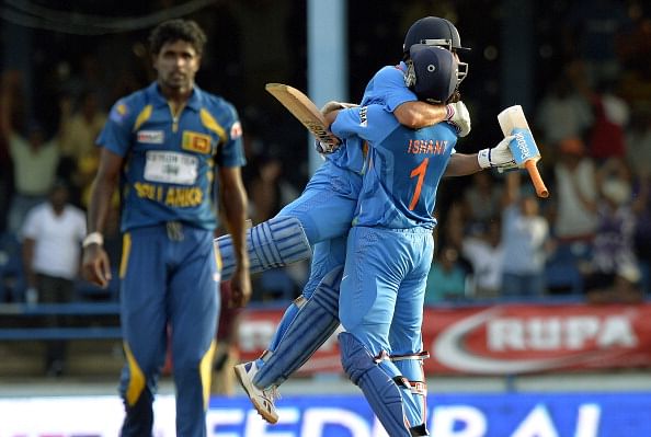 Dhoni (C-L) is lifted off the ground by teammate Ishant Sharma after hitting a six to seal their victory during the final of the Tri-Nation series against Sri Lanka at the Queen&#039;s Park Oval stadium in Port of Spain on July 11, 2013. India defeated Sri Lanka by 1 wicket to win the series. (Getty Images)