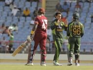 Pakistan bowler Saeed Ajmal (C) celebrates with Umar Akmal (R) (Getty Images)