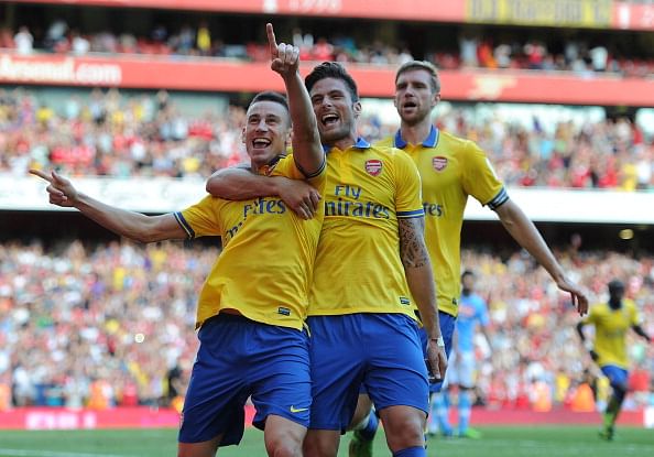 Laurent Koscielny (L) celebrates scoring Arsenal&#039;s second goal with Olivier Giroud (C) and Per Mertesacker