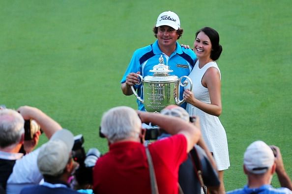 Jason Dufner of the United States and his wife Amanda pose with the Wanamaker Trophy on the 18th green after his two-stroke victory at the 95th PGA Championship at Oak Hill Country Club on August 11, 2013 in Rochester, New York.  (Getty Images)