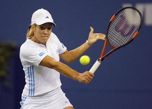 Justine Henin-Hardenne returns a shot to Jennifer Capriati during the US Open 2003 semi-final