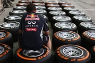 An Infiniti Red Bull Racing mechanic works on wheels and Pirelli tyres in the paddock during practice for the Bahrain Formula One Grand Prix at the Bahrain International Circuit on April 19, 2013 in Sakhir, Bahrain. (Getty Images)