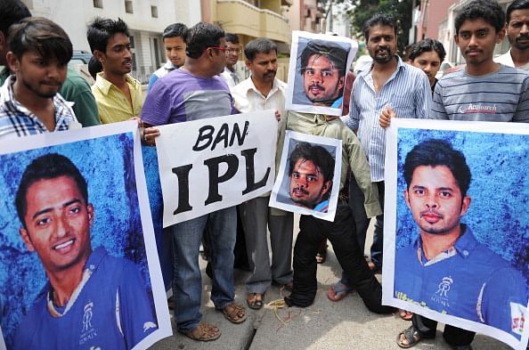Demonstrators hold posters and shout slogans against Indian cricketer Sreesanth and two other domestic Twenty20 cricketers