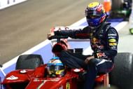 Fernando Alonso gives Mark Webber a lift to the pit lane on his Ferrari