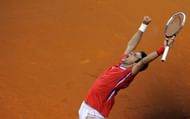 Novak Djokovic celebrates after winning against Canada's Milos Raonic