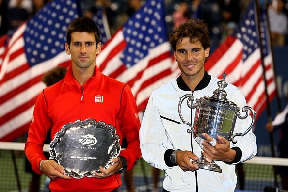 Rafael Nadal of Spain poses with the US Open Championship trophy next to Novak Djokovic of Serbia as he celebrates winning the men&rsquo;s singles final