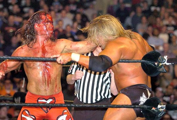 A bloody Shawn Michaels and Triple H