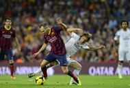 Andres Iniesta (L) vies with Luka Modric