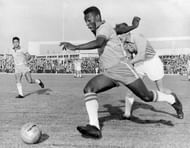 Brazilian forward Pele dribbles past a defender du