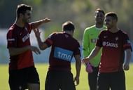 Portuguese midfielder Andre Martins (2L) is teased by teammates Nelson Oliveira (L), Beto (3L) and Antunes (R) during a practice session in Praia Del Rey near Obidos on October 9, 2013, on the third day their training camp in preparation for the World Cup 2014 qualifying football matches Portugal vs Israel