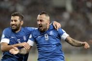 Konstantinos Mitroglou celebrates with his teammate Dimitris Siovas after scoring
