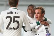 Mario Gotze is congratulated by teammates Thomas Muller and David Alaba for his goal