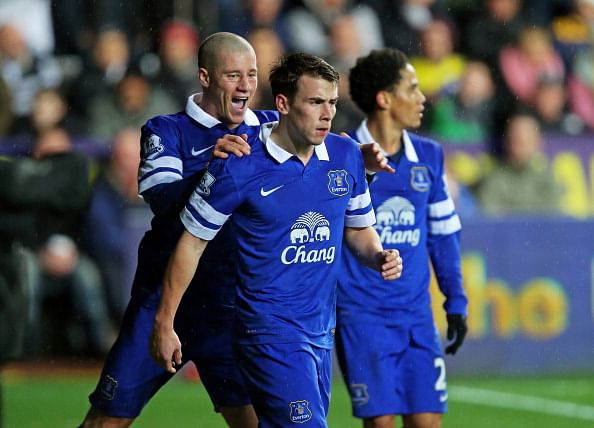 SWANSEA, WALES - DECEMBER 22:  Seamus Coleman (C) of Everton is congratulated by teammate Ross Barkley (L) of Everton after scoring the opening goal during the Barclays Premier League match between Swansea City and Everton at the Liberty Stadium on December 22, 2013 in Swansea, Wales.  (Photo by Clive Rose/Getty Images)