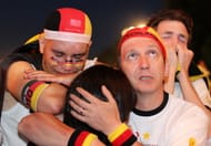 BERLIN - JULY 07: German football supporters watch the 2010 FIFA World Cup semi final match between Germany and Spain at a live public viewing on a large screen monitor at FIFA Fanmeile on July 7, 2010 in Berlin, Germany. (Photo by Matthias Kern/Getty Images)