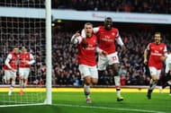 Podolski celebrates with Yaya Sanogo