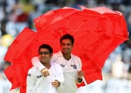 Indian cricketers Irfan Pathan (R) and Piyush Chawla use an umbrella for shade as they walk off the ground after bringing refreshments to their teammates during a drinks break on the third day of the first Test match between India and South Africa at The M.A. Chidambaram Stadium in Chennai on March 28, 2008. At the tea interval Indian batsman Virender Sehwag has scored 218 runs as India have scored 350 runs in 78 with the loss of one wicket in reply to South Africa's first innings total of 540 runs. AFP PHOTO/Dibyangshu SARKAR (Photo credit should read DIBYANGSHU SARKAR/AFP/Getty Images)