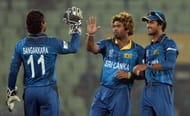 Sri Lankan bowler Lasith Malinga (C) celebrates with teammates Kumar Sangakkara (L) and Dinesh Chandimal (R) after taking the wicket of unseen Indian batsman Virat Kohli during the ICC World Twenty20 cricket tournament warm-up match between India and Sri Lanka at the Sher-e-Bangla National Cricket Stadium in Dhaka on March 17, 2014. AFP PHOTO / PUNIT PARANJPE (Photo credit should read PUNIT PARANJPE/AFP/Getty Images)