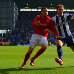 West Brom defender Gareth McAuley's clearance breaks a laptop