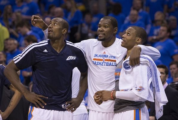 Serge Ibaka #9, Kevin Durant #35 and Russell Westbrook #0 of the Oklahoma City Thunder talk during the Memphis Grizzlies in Game One of the Western Conference Quarterfinals of the NBA Playoffs at Chesapeake Energy Arena on April 19, 2014 in Oklahoma City, Oklahoma