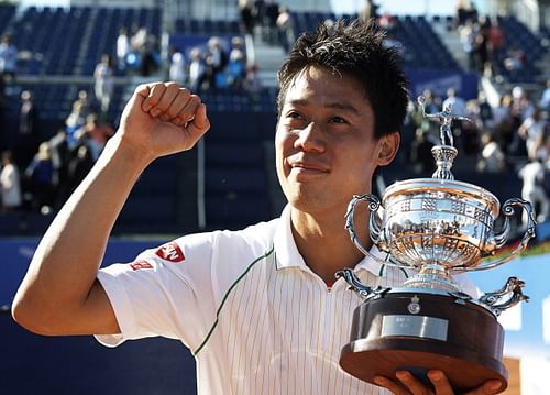 Kei Nishikori of Japan poses with the trophy after day eight of the ATP Barcelona Open Banc Sabadell at the Real Club de Tenis Barcelona on April 27, 2014 in Barcelona, Spain.