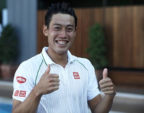 Kei Nishikori of Japan after celebrating his victory into the club's pool after his victory against Santiago Giraldo of Colombia after day eight of the ATP Barcelona Open Banc Sabadell at the Real Club de Tenis Barcelona on April 27, 2014 in Barcelona, Spain.