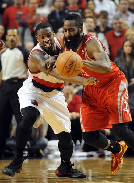 Wesley Matthews #2 of the Portland Trail Blazers pokes the ball away from James Harden #13 of the Houston Rockets in the fourth quarter of Game Four of the Western Conference Quarterfinals during the 2014 NBA Playoffs at the Moda Center on April 27, 2014 in Portland, Oregon. The Blazers won the game 123-120.