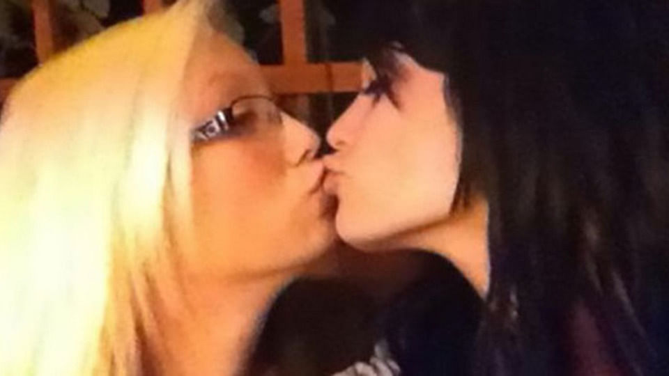 WWE Divas Champion Paige kissing a girl.