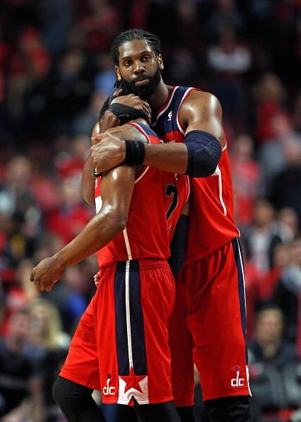 Nene #42 of the Washington Wizards hugs teammate John Wall #2 at the end of the game against the Chicago Bulls in Game Five of the Eastern Conference Quarterfinals during the 2014 NBA Playoffs at the United Center on April 29, 2014 in Chicago, Illinois. The Wizards defeated the Bulls 75-69 to win the series four game to one.