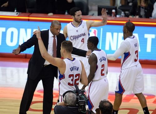 Los Angeles Clippers coach Doc Rivers (L) celebrates with players, from left, Blake Griffin (32), Darren Collison (2), J.J. Redick (4) and Chris Paul (30  at the NBA playoff game after the Clippers defeated the Golden State Warriors 113-103, April 29, 2014 at Staples Center in Los Angeles, California.