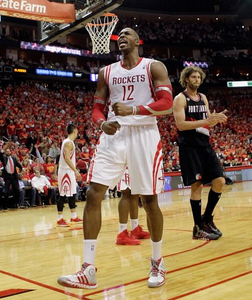 Dwight Howard #12 of the Houston Rockets gets the crowd going after a defensive stop with less than two minutes to go in Game 5 of the Western Conference Quarterfinals during the 2014 NBA Playoffs at the Toyota Center on April 30, 2014 in Houston, Texas. Houston won 108-98.