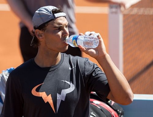 Rafael Nadal of Spain has a drink in a practice session during day one of the Mutua Madrid Open tennis tournament at the Caja Magica on May 3, 2014 in Madrid, Spain.