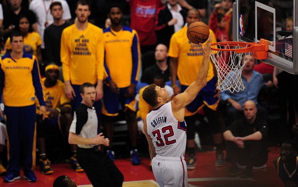 Players on the bench for the Golden State Warriors can only watch as Blake Griffin of the Los Angeles Clippers scores uncontested late in game 7 of their NBA first round series on May 3, 2014 in Los Angeles, California, where the LA Clippers defeated the GS Warriors 126-121. 