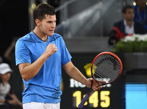 Austrian player Dominic Thiem celebrates after winning his men's singles second round tennis match against Swiss player Stanislas Wawrinka at the Madrid Masters at the Magic Box (Caja Magica) sports complex in Madrid on May 6, 2014. 