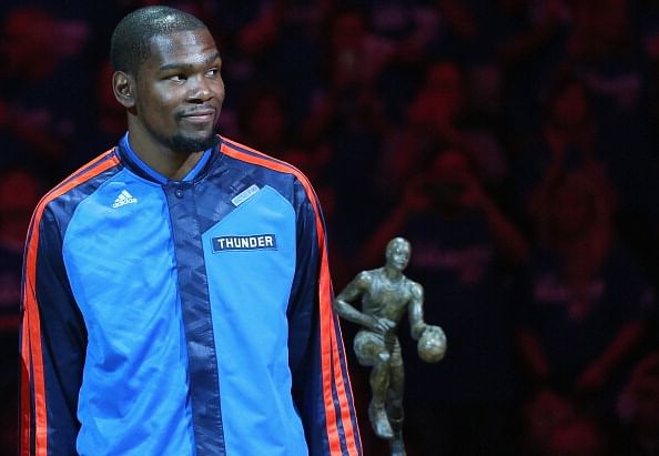 Kevin Durant of the Oklahoma City Thunder with the Maurice Podoloff Trophy after being named the 2013-14 KIA Player of the Year before Game Two of the Western Conference Semifinals during the 2014 NBA Playoffs at Chesapeake Energy Arena on May 7, 2014 in Oklahoma City, Oklahoma.