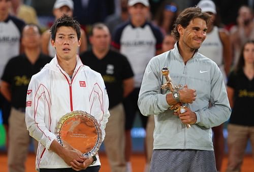 Rafael Nadal of Spain and  Kei Nishikori of Japan hold their trophies after Nishikori retired injured in the third set in their final match during day nine of the Mutua Madrid Open tennis tournament at the Caja Magica on May 11, 2014 in Madrid, Spain. 