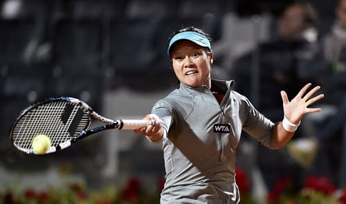 Na Li of China  returns a ball  to Casey Dell'Acqua during their match as part of Rome WTA tennis Masters on May 13, 2014 at the Foro Italico in Rome. 