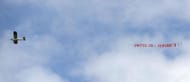 Airplane with the banner 'United 20 - Gerrard 0' flies over Anfield