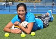 Garbine Muguruza posing with a dog