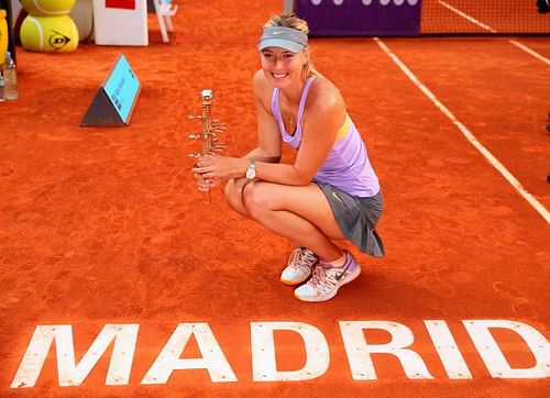 Maria Sharapova posing with the trophy after defeating Simona Halep in the Madrid final