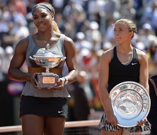 Serena Williams (L) of the US poses with the trophy after winning the WTA Rome's Tennis Masters final against Sara Errani (R) of Italy on May 18, 2014, at the Foro Italico in Rome. Williams won 6-3, 6-0. 