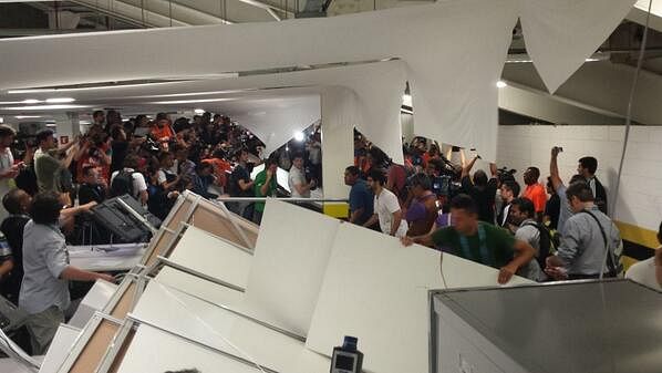 Chilean fans break through security barrier at the Maracana; invade press room