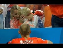 Netherlands' Arjen Robben consoles his son who is in tears after defeat against Argentina
