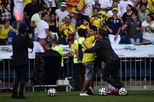James Rodriguez's hugs pitch invader during his presentation at Santiago Bernabeu